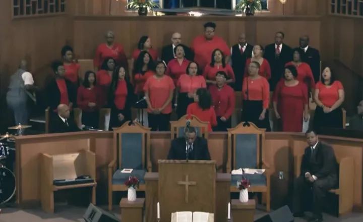 The Freedom Faith Mass Choir singing in red