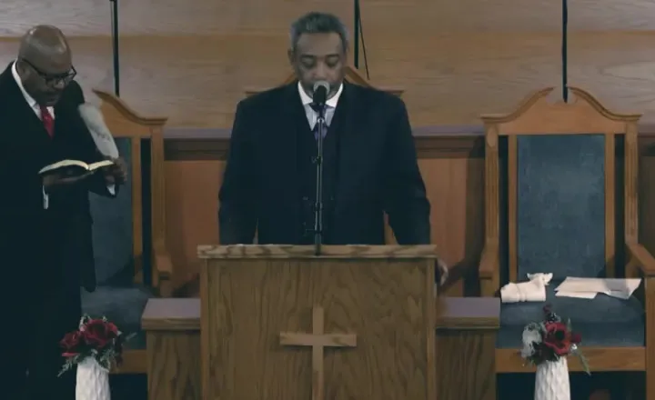 Pastor Hayes at the pulpit during Sunday worship